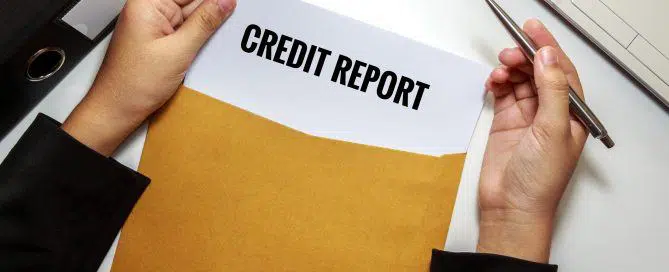 Businesswoman opening Credit report document in letter envelope