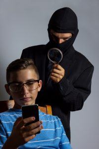masked man spying data from smartphone of teen