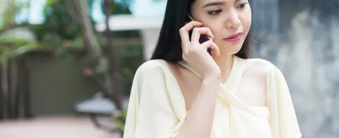 Unhappy Asian woman on phone - relationship and family concept