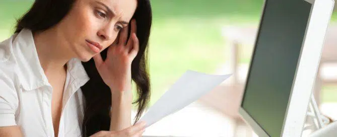 Woman looking worried reading a document