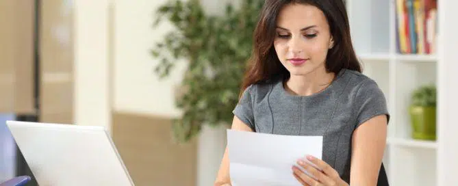 Businesswoman reading a letter at office