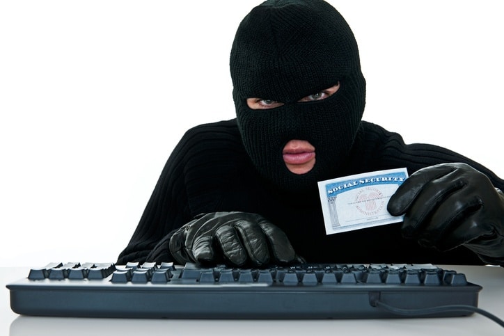 Identity Thief With Mask Using Keyboard